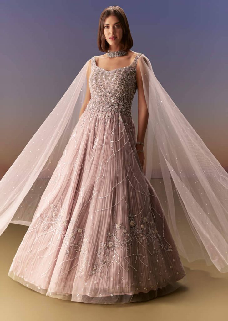 Pastel Pink Gown With Sheer Cape Drape And Heavy Embroidery

